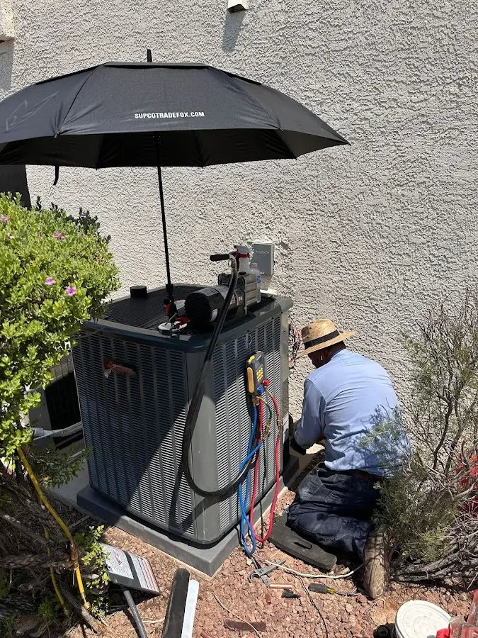 HVAC technician performing outdoor AC maintenance in East Chicago